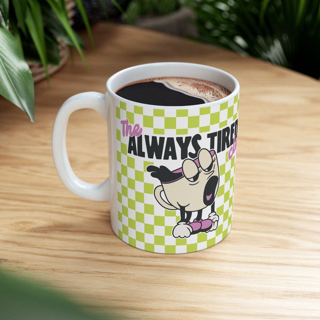 The Always Tired Club Mug — Cute Yawning Coffee Cup Character on Green Checkerboard Ceramic Coffee Cup (11oz, 15oz)