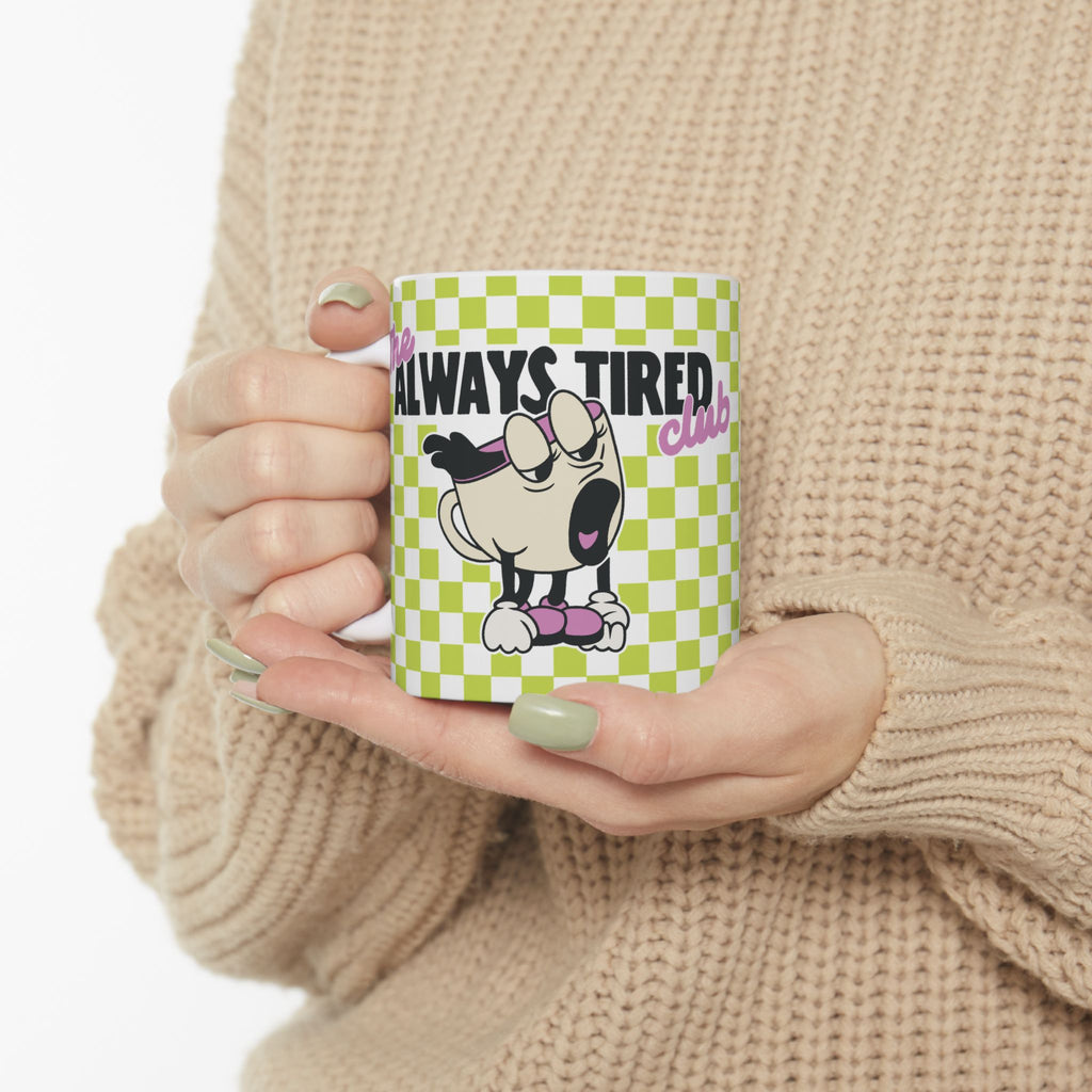 The Always Tired Club Mug — Cute Yawning Coffee Cup Character on Green Checkerboard Ceramic Coffee Cup (11oz, 15oz)